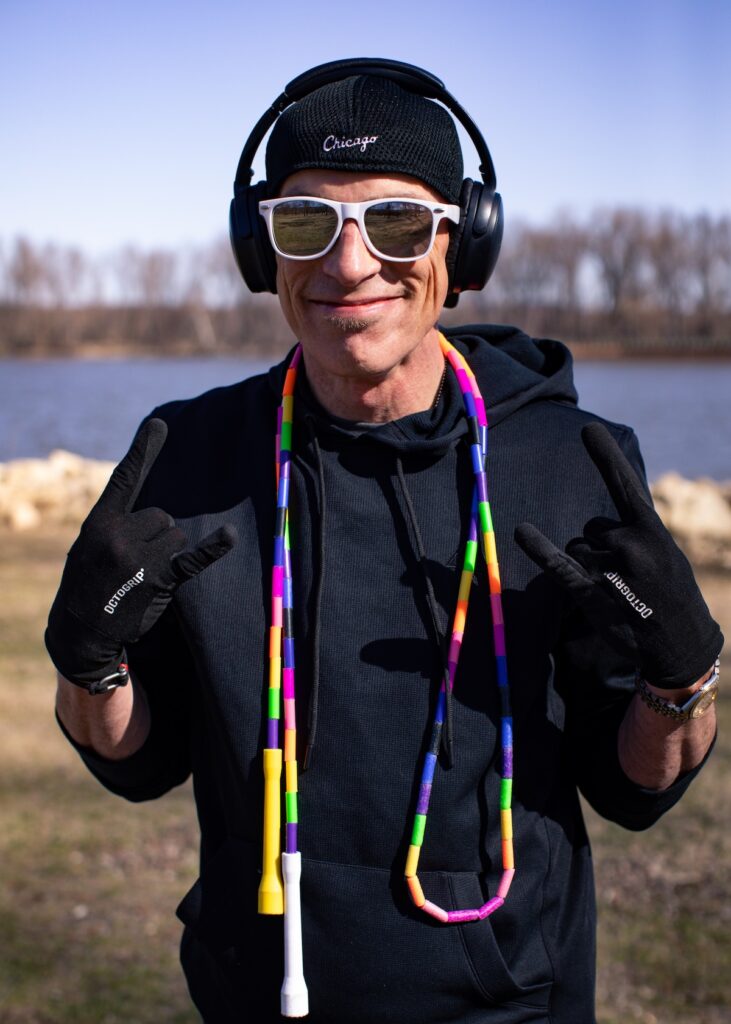 Dizzy Skips smiling with a jump rope, hat, sunglasses, and headphones